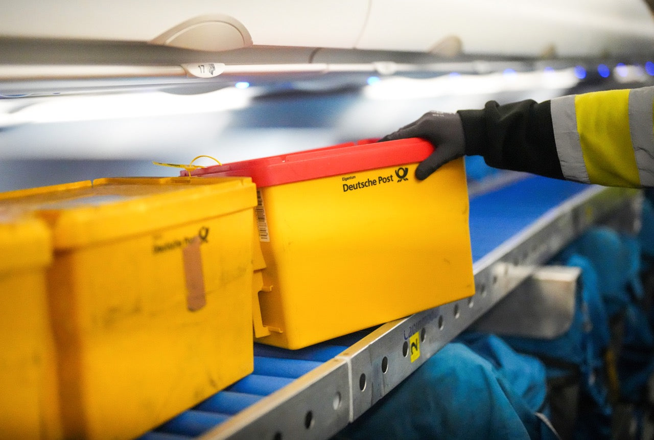 Person sorting mail in a Deutsche Post sorting center