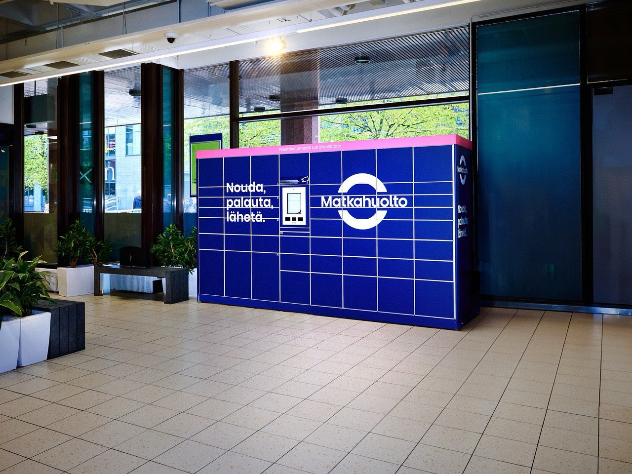 Blue and pink parcel locker with Matkahuolto branding in an indoor setting